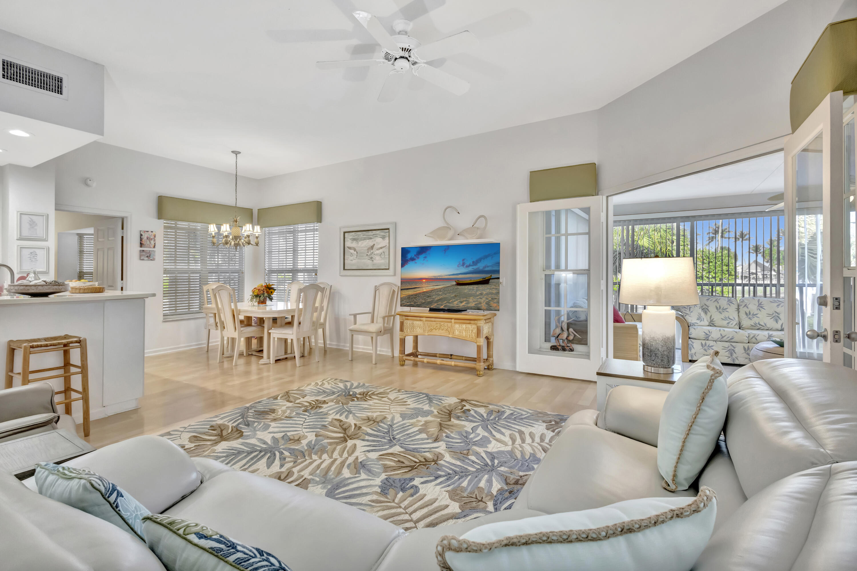 411 Northeast Plantation Road, Unit 522 Stuart, FL 34996 - Photo 7 of 52 a living room with furniture and a table