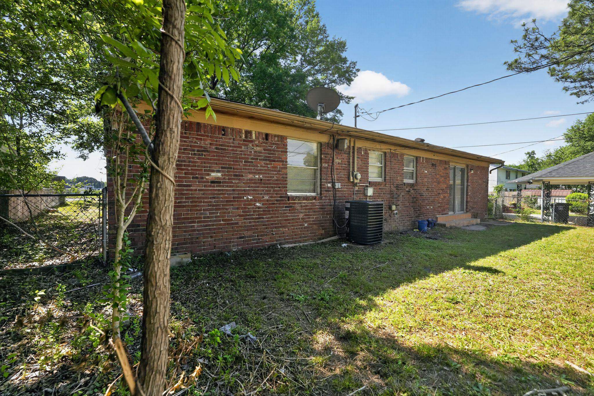 3445 Powers Road Memphis, TN 38128 - Photo 5 of 35 Brick exterior featuring multiple windows and a rear entry door