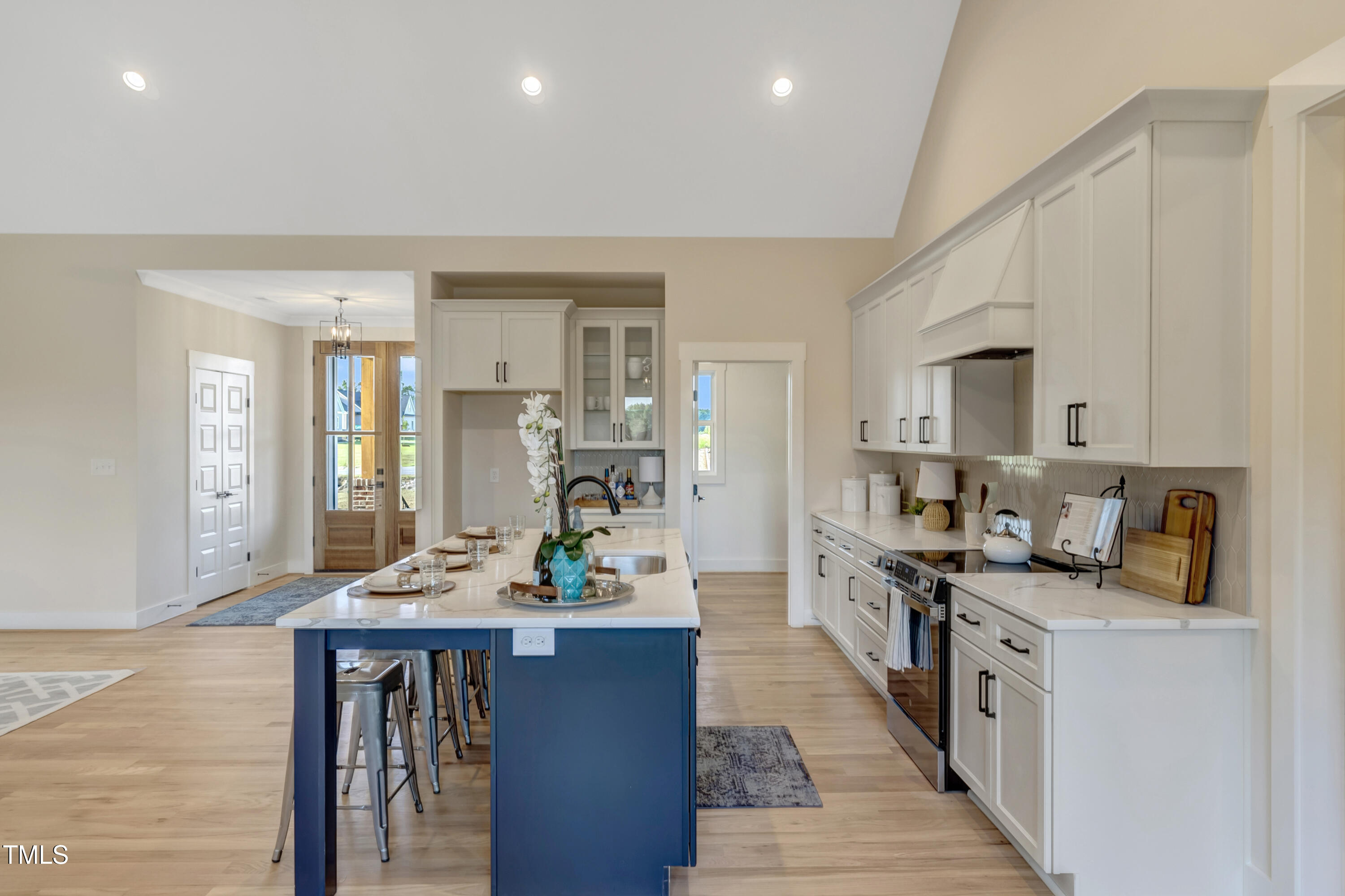 0 Radio Tower Road Wilson, NC 27893 - Photo 5 of 48 a kitchen with stainless steel appliances kitchen island granite countertop a stove a sink a refrigerator and white cabinets with wooden floor