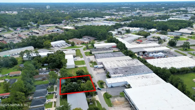 an aerial view of a houses with a yard
