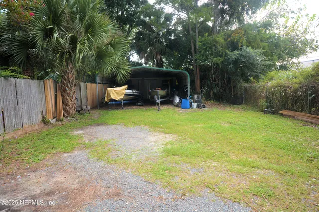 an outdoor sitting area with couch and a potted plant