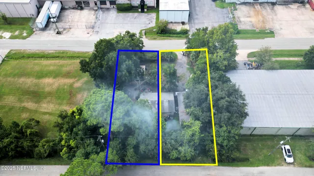 a view of yellow house with a yard and sitting area