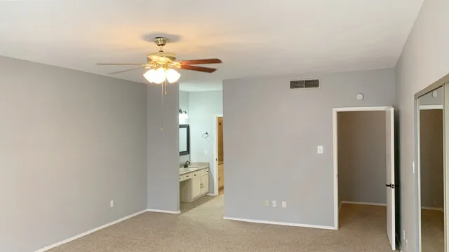 a view of a livingroom with a chandelier fan