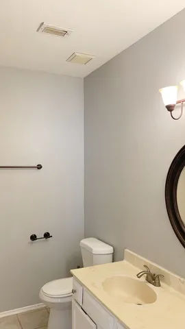 a bathroom with a toilet sink and a mirror