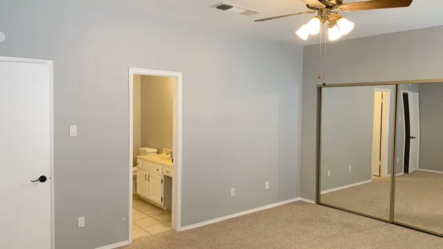 a view of a hallway with a chandelier fan