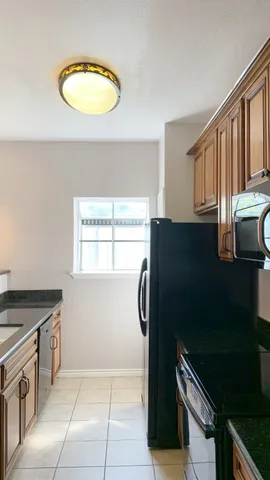 a kitchen with a refrigerator and a stove