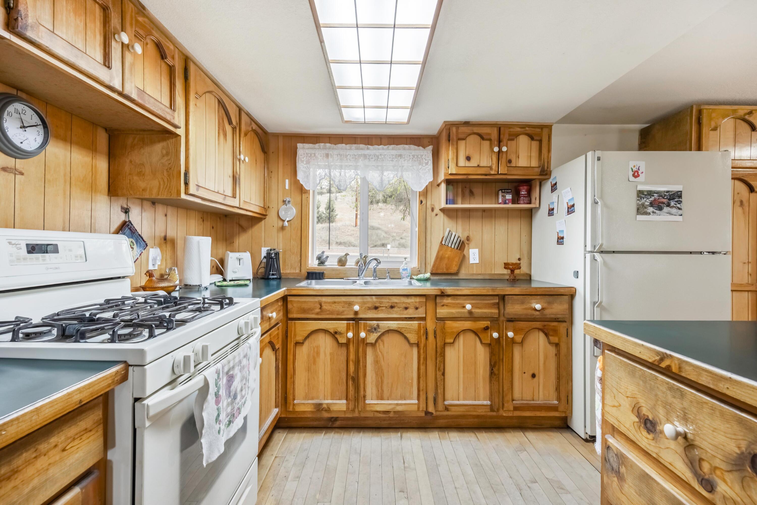 2010 Northeast Laughlin Road Prineville, OR 97754 - Photo 11 of 39 a kitchen with stainless steel appliances granite countertop a stove and a refrigerator