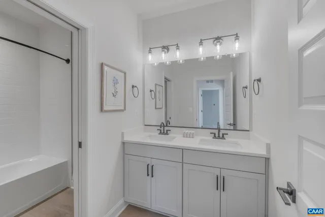 a bathroom with a double vanity sink and a mirror