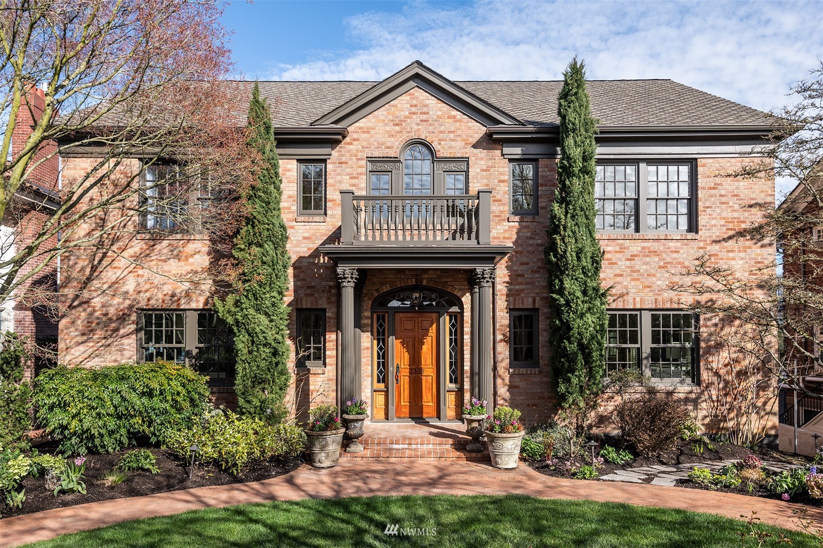 front view of house with a yard and a fountain