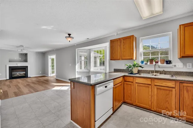 a kitchen with granite countertop a sink stove and cabinets