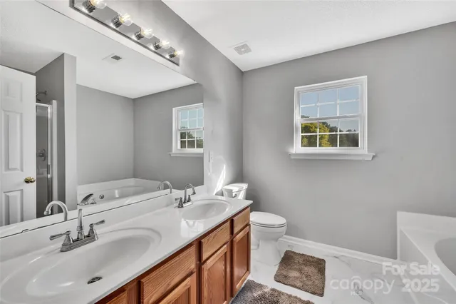 a bathroom with a double vanity sink and a mirror