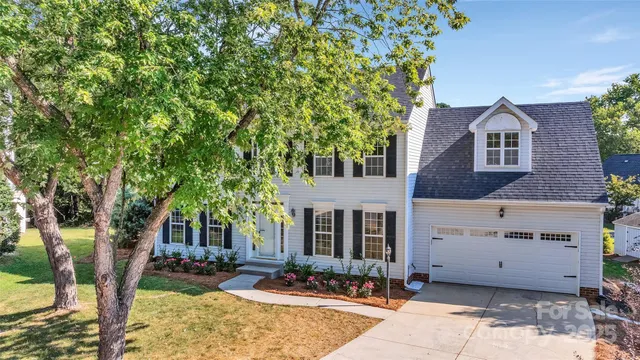 front view of a house with a tree