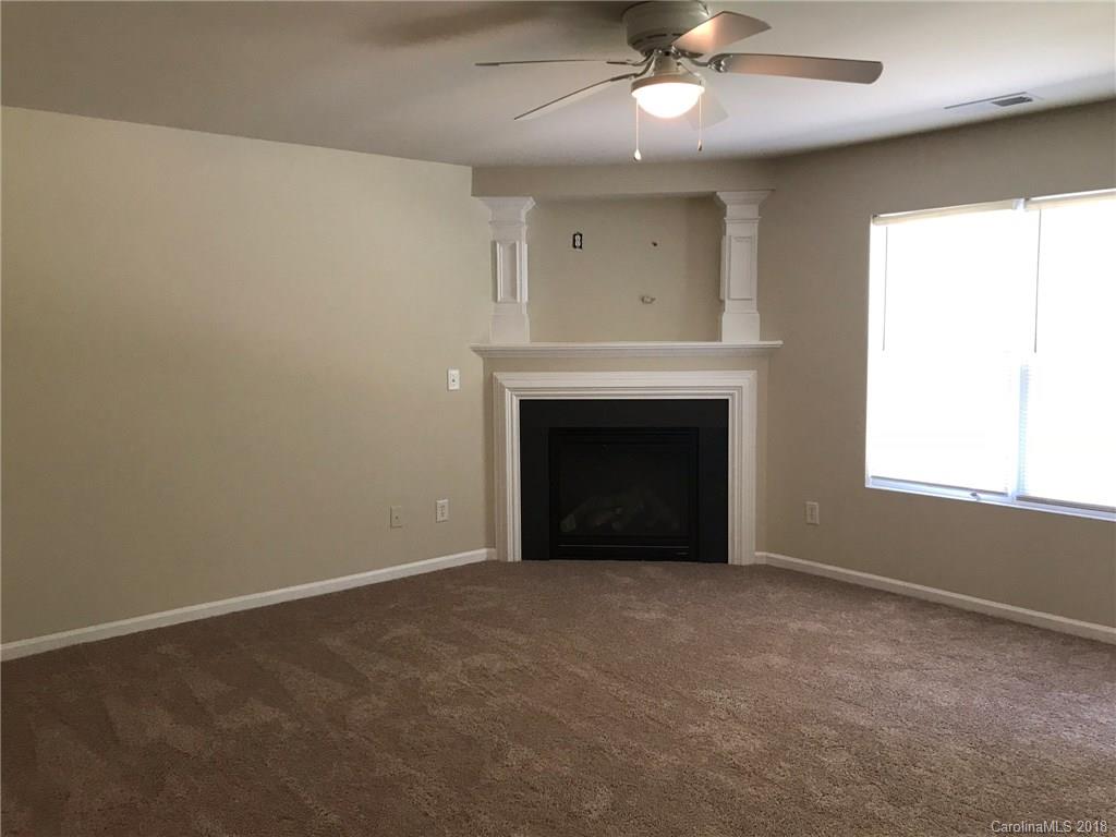 838 Rook Road Charlotte, NC 28216 - Photo 2 of 13 an empty room with windows and fireplace