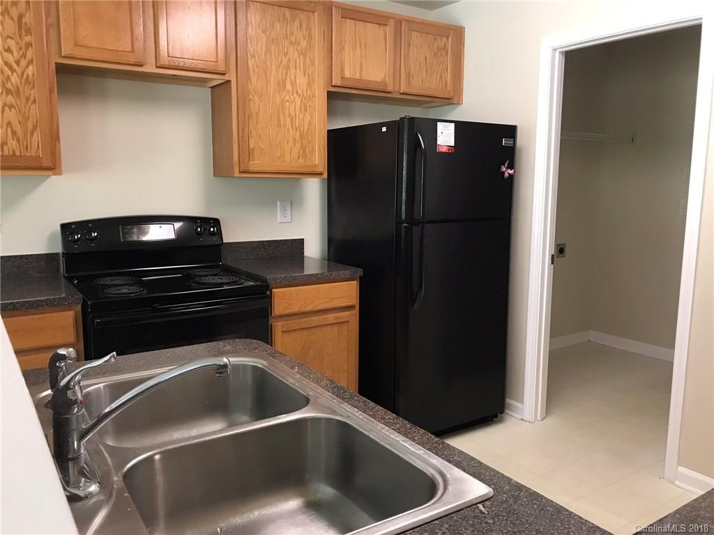 838 Rook Road Charlotte, NC 28216 - Photo 3 of 13 a kitchen with a refrigerator and a cabinets
