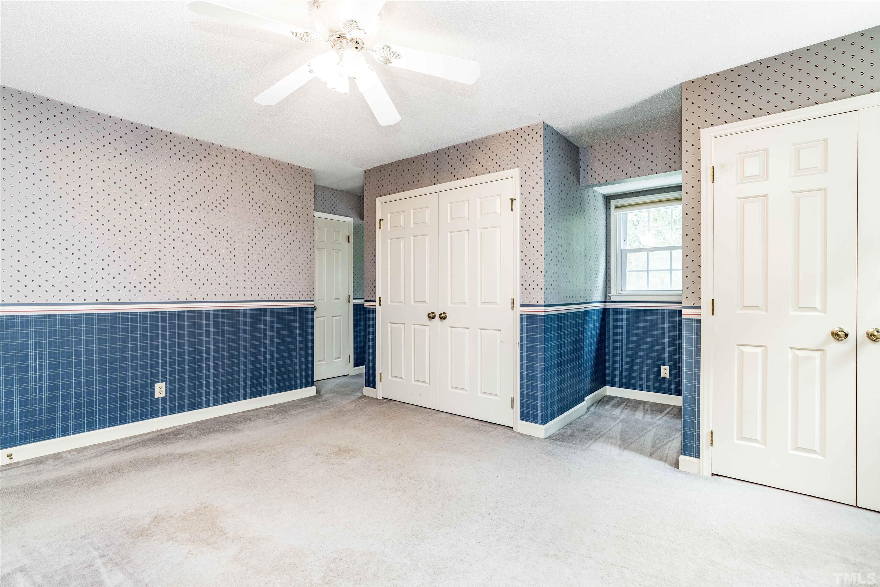 8424 Crowder Road Raleigh, NC 27603 - Photo 32 of 70 an empty room with windows and cabinet
