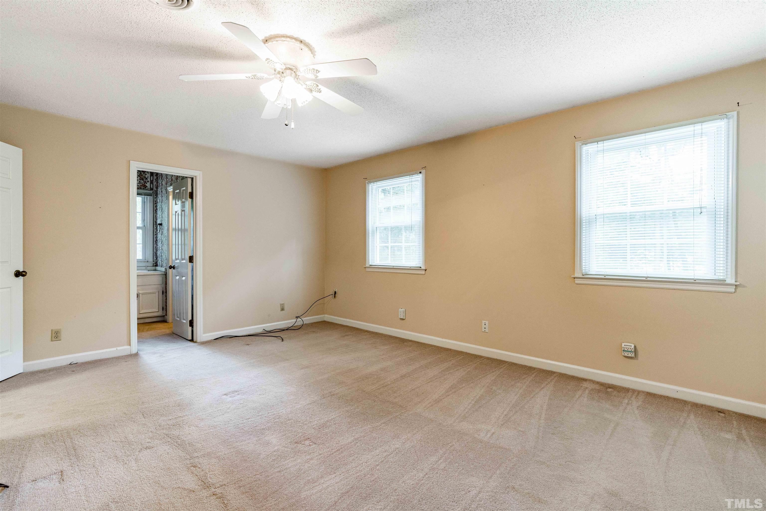 8424 Crowder Road Raleigh, NC 27603 - Photo 34 of 70 an empty room with windows and fan