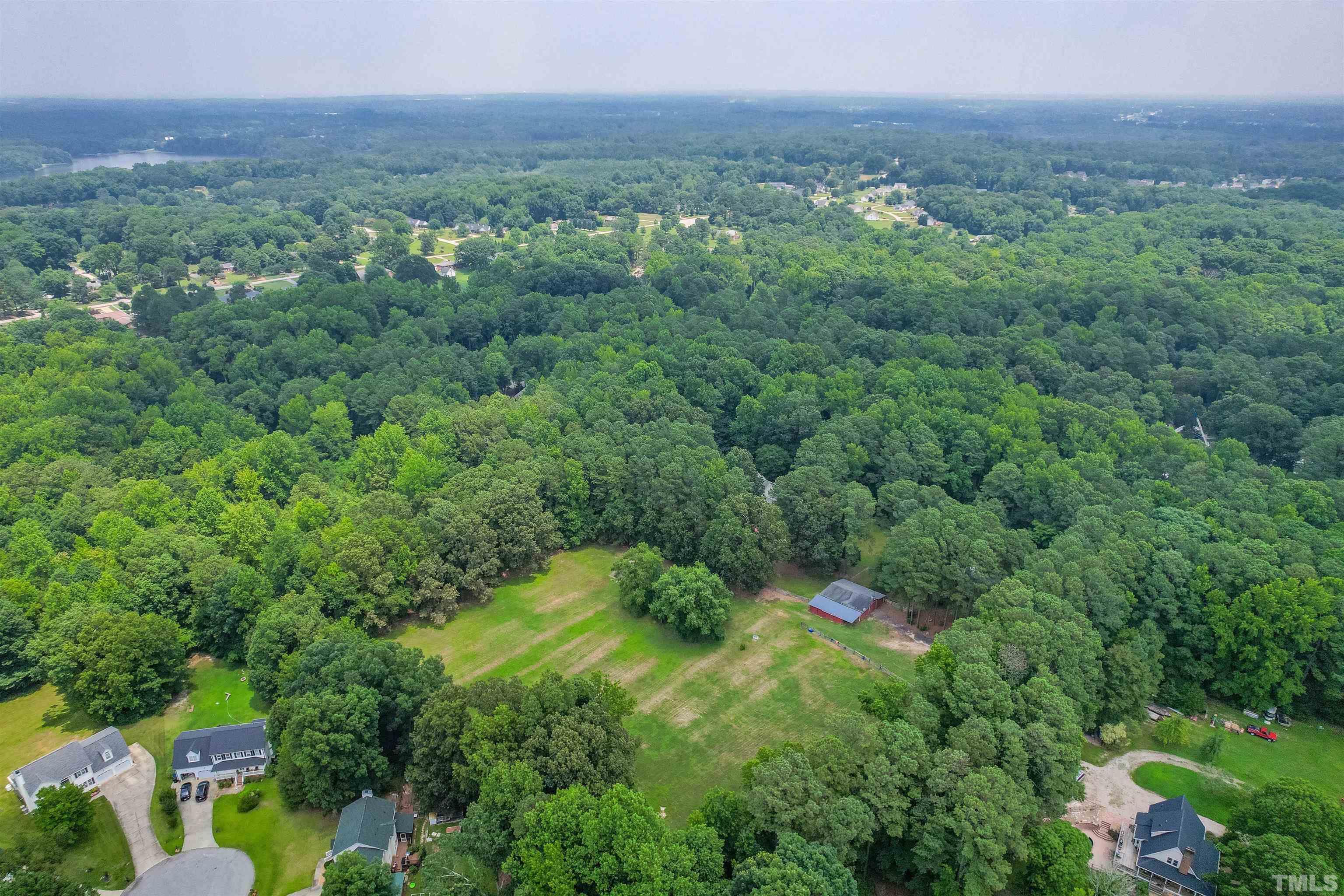 8424 Crowder Road Raleigh, NC 27603 - Photo 68 of 70 a view of a lush green forest with trees and some houses