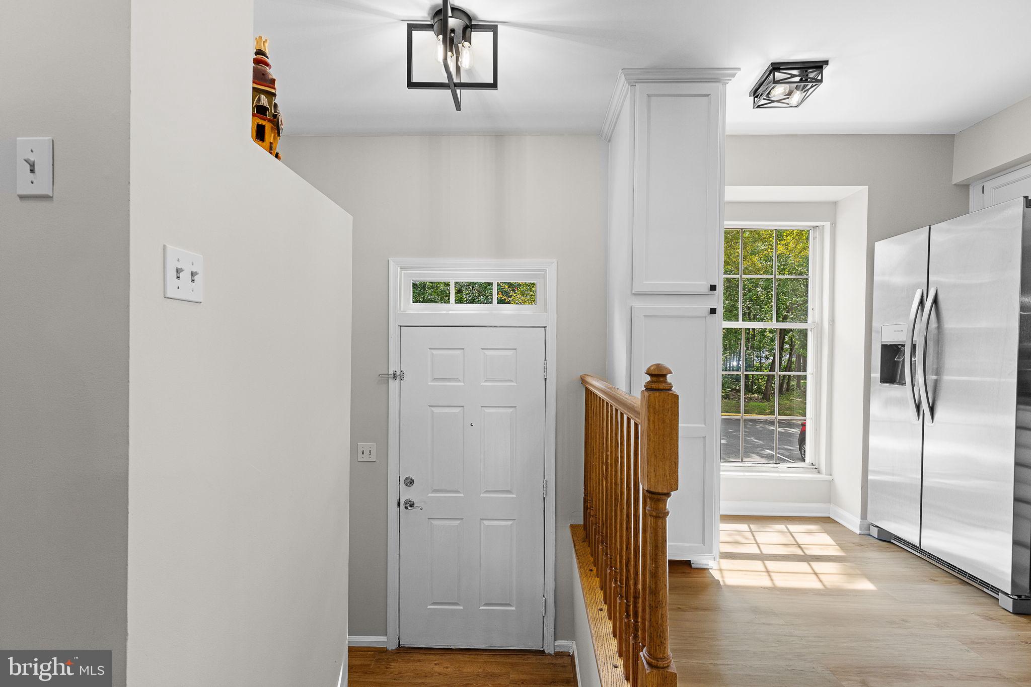 6582 Skylemar Trail Centreville, VA 20121 - Photo 11 of 46 a view of hallway with wooden floor and cabinet