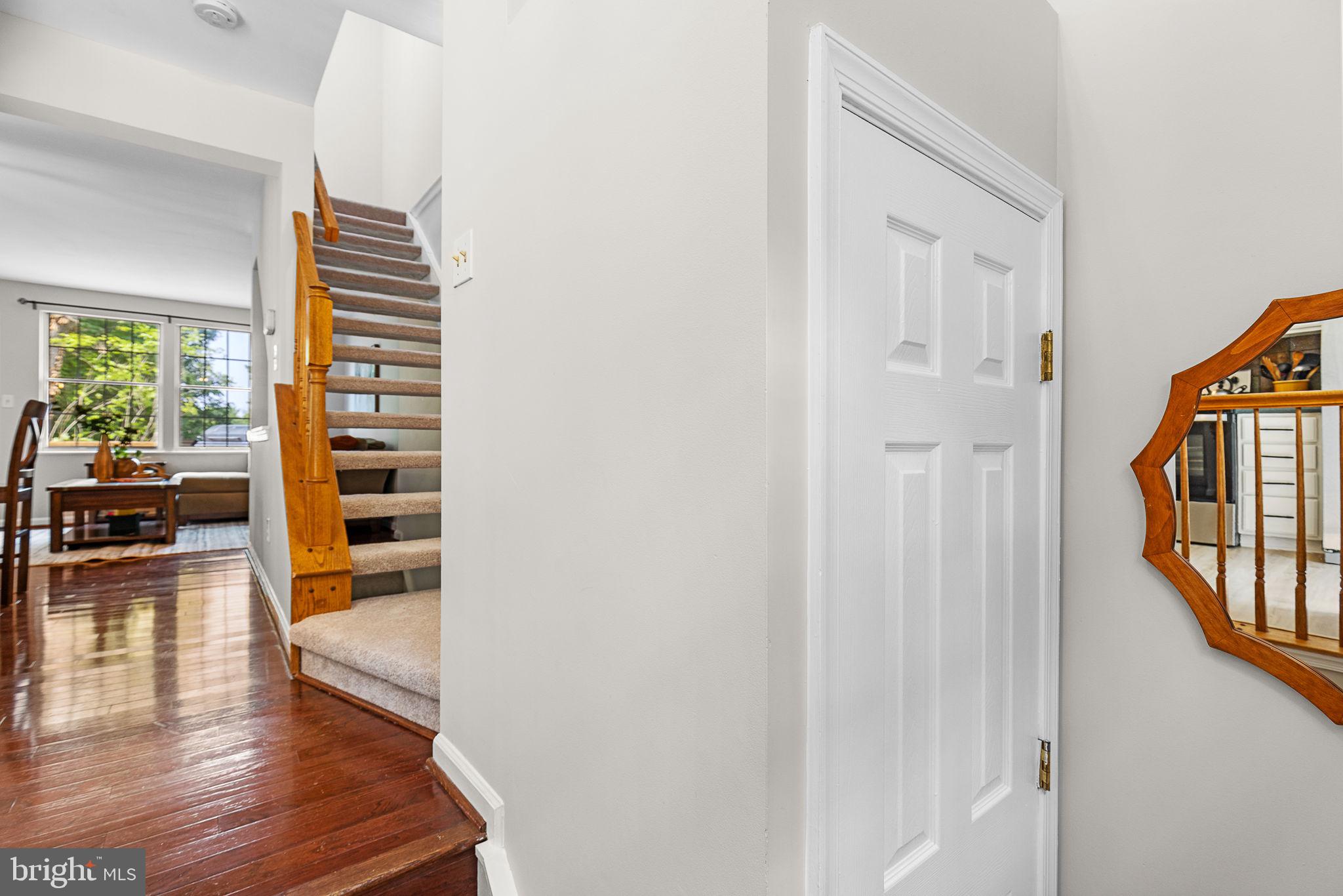 6582 Skylemar Trail Centreville, VA 20121 - Photo 12 of 46 a view of a hallway with wooden floor and staircase