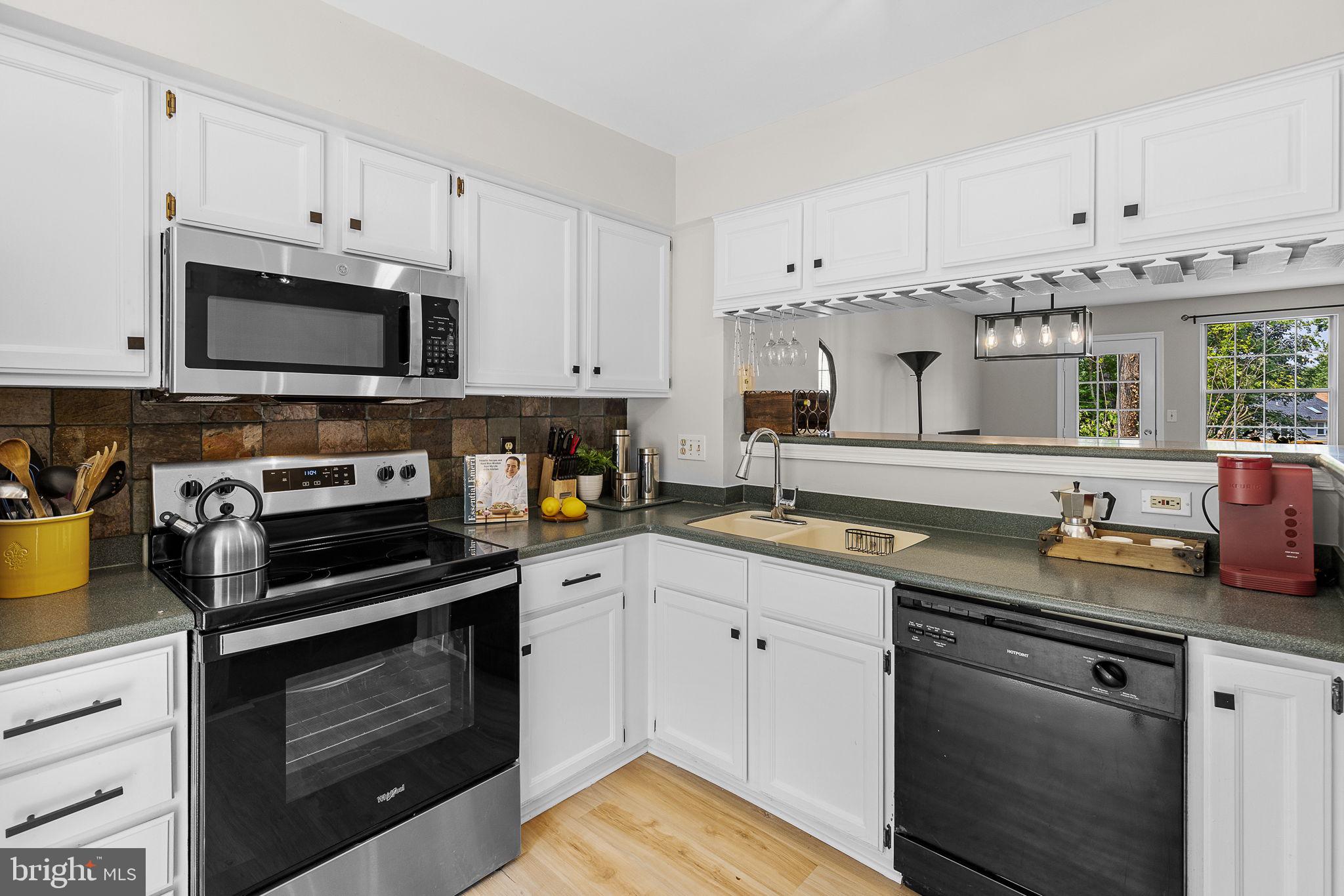 6582 Skylemar Trail Centreville, VA 20121 - Photo 15 of 46 a kitchen with cabinets stainless steel appliances and a sink