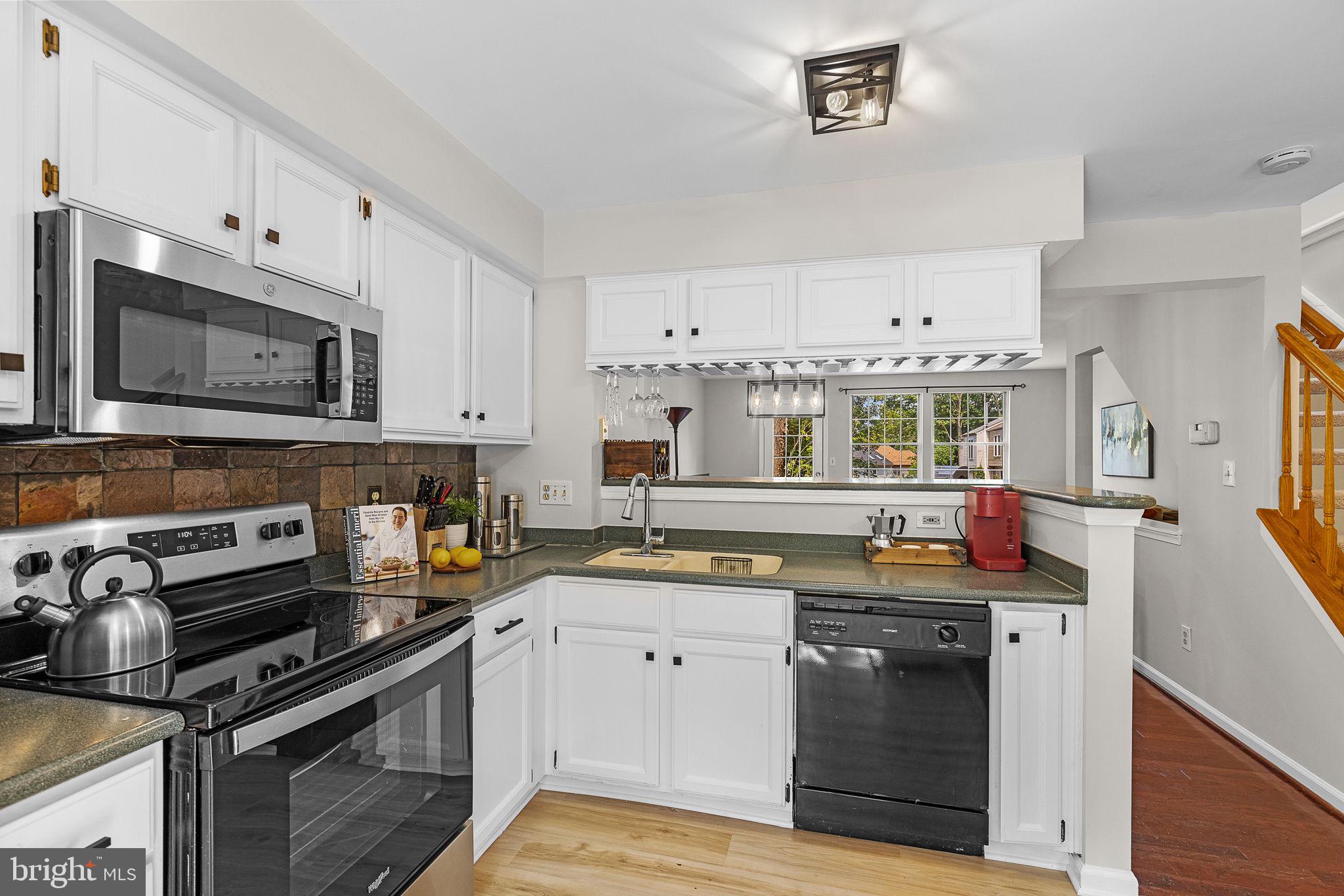 6582 Skylemar Trail Centreville, VA 20121 - Photo 16 of 46 a kitchen with stainless steel appliances a stove a sink and a microwave