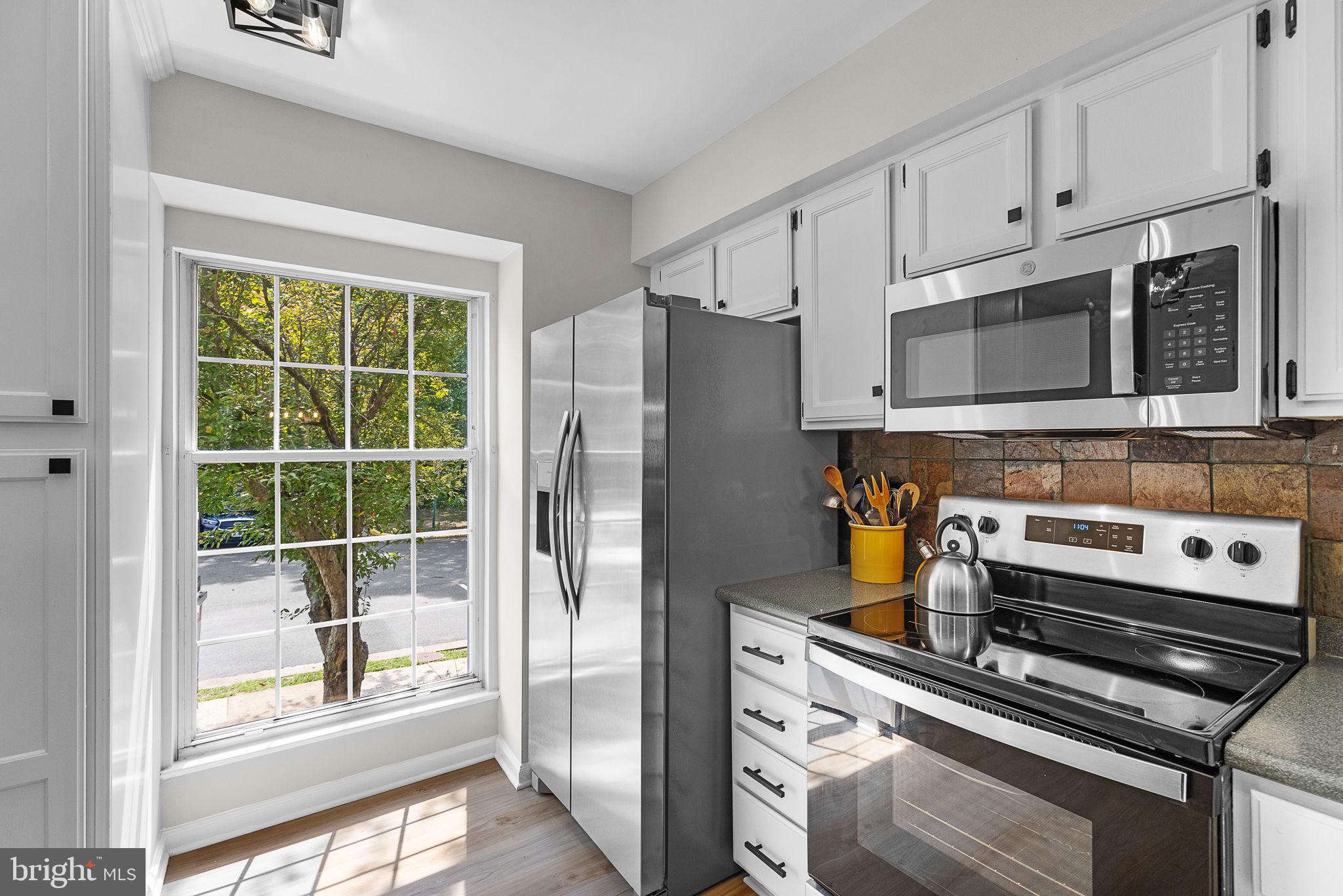 6582 Skylemar Trail Centreville, VA 20121 - Photo 17 of 46 a kitchen with appliances a refrigerator and a window