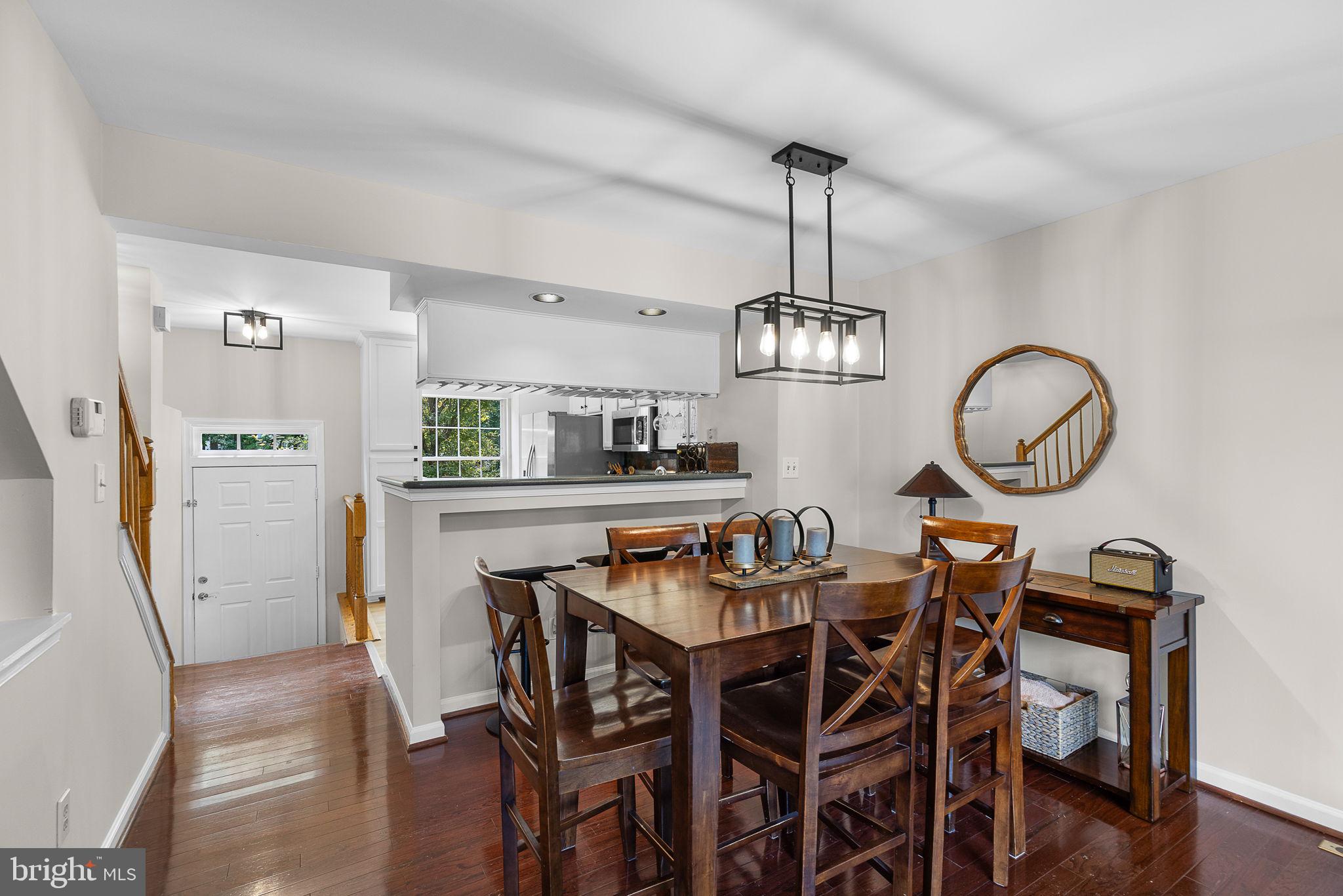 6582 Skylemar Trail Centreville, VA 20121 - Photo 19 of 46 a view of a dining room with furniture a chandelier and wooden floor