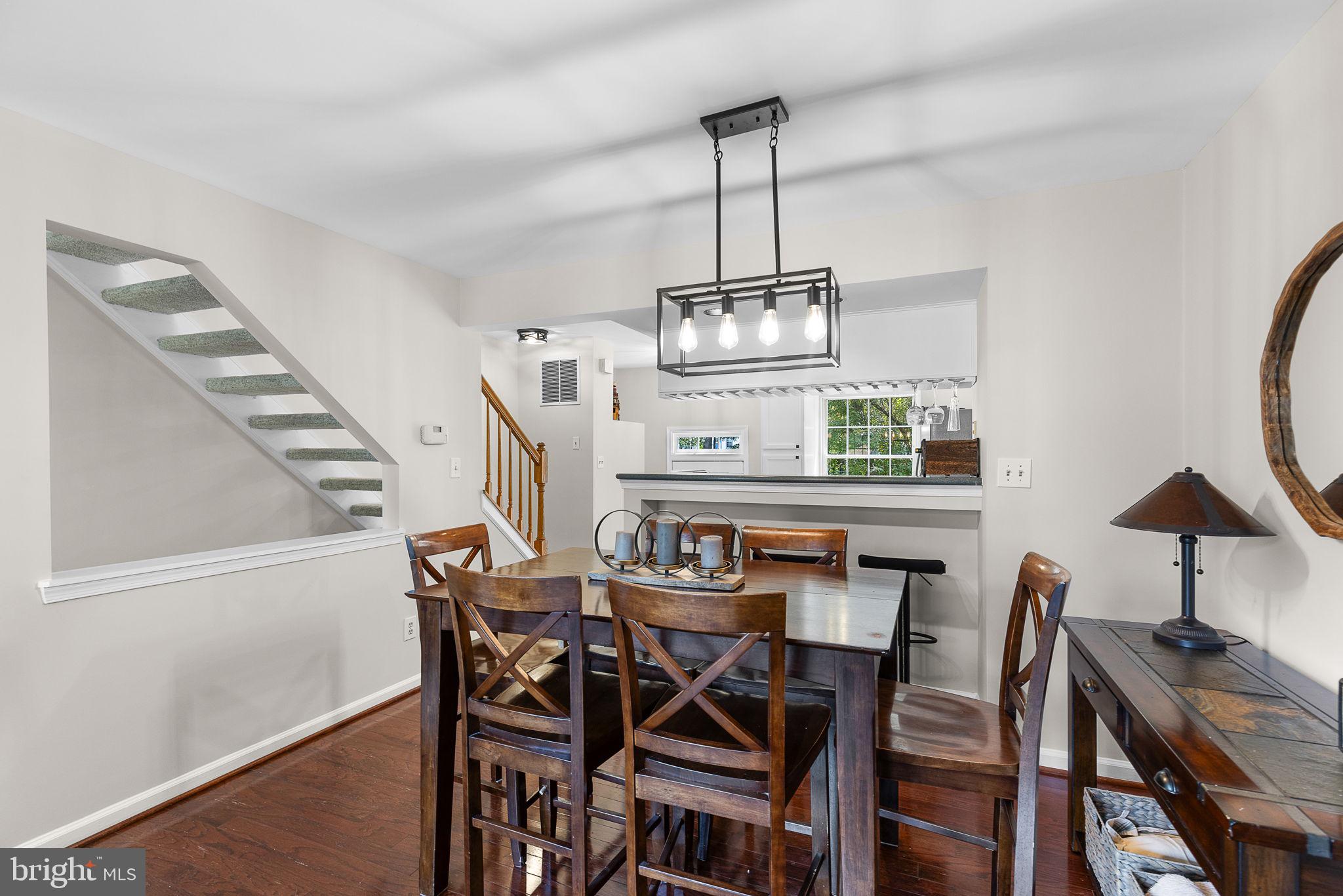 6582 Skylemar Trail Centreville, VA 20121 - Photo 20 of 46 a view of a dining room with furniture and wooden floor