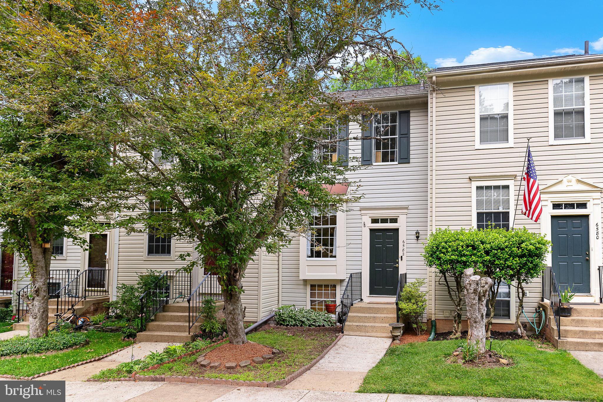 6582 Skylemar Trail Centreville, VA 20121 - Photo 2 of 46 a front view of a house with a yard and potted plants