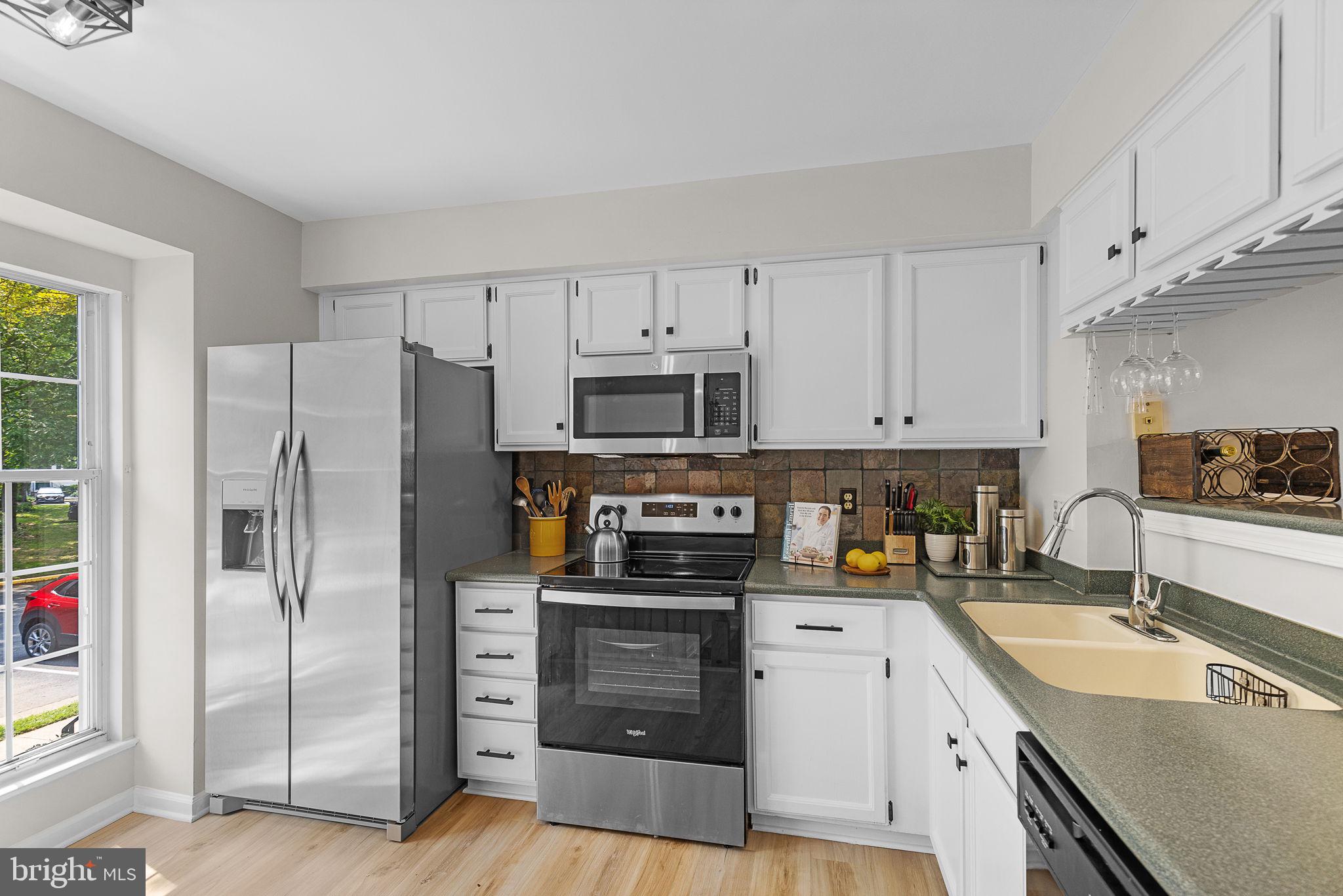 6582 Skylemar Trail Centreville, VA 20121 - Photo 3 of 46 a kitchen with granite countertop a refrigerator stove and oven