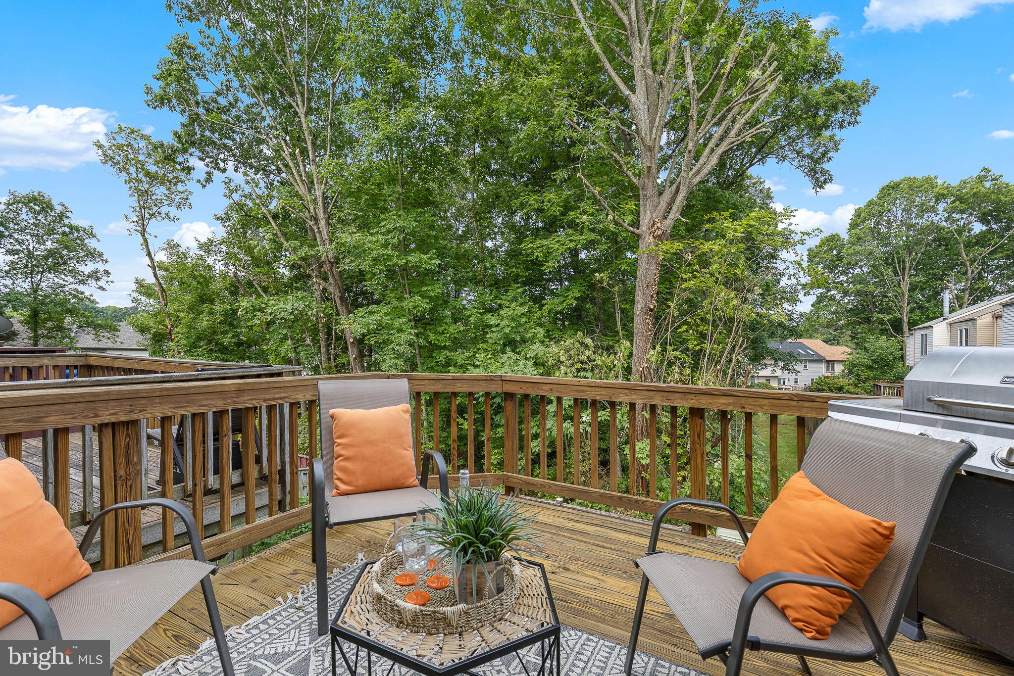 6582 Skylemar Trail Centreville, VA 20121 - Photo 6 of 46 a balcony with wooden floor and outdoor seating
