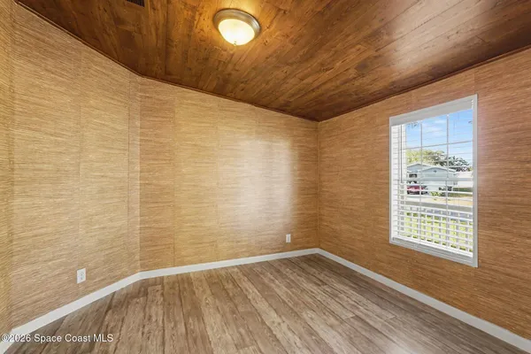 a living room with hard wood floors and a window