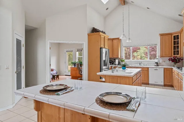 a kitchen with stainless steel appliances granite countertop a sink stove and cabinets