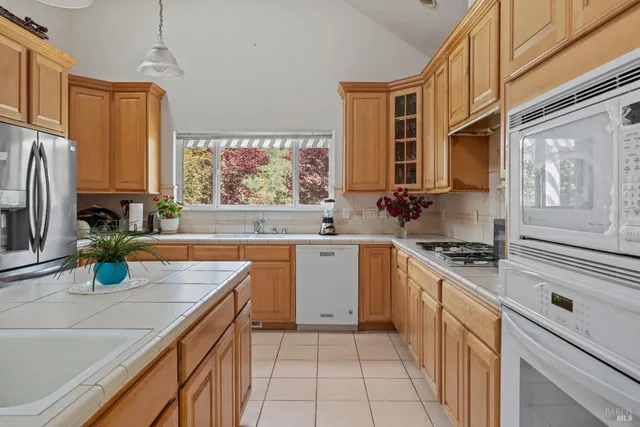 a kitchen with stainless steel appliances a stove sink and cabinets