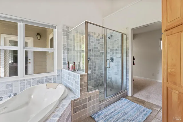 a bathroom with a granite countertop tub shower and sink