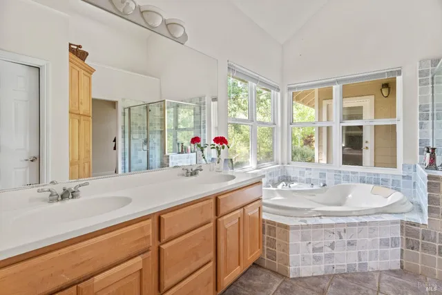 a bathroom with a sink double vanity and window
