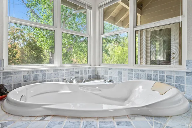 a bath tub sitting next to a window
