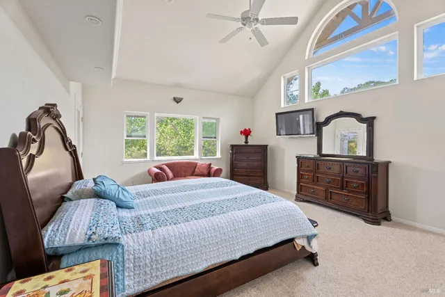 a bedroom with a bed window and dresser