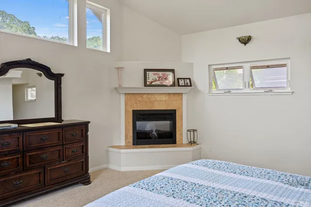 a bedroom with a bed and a fireplace