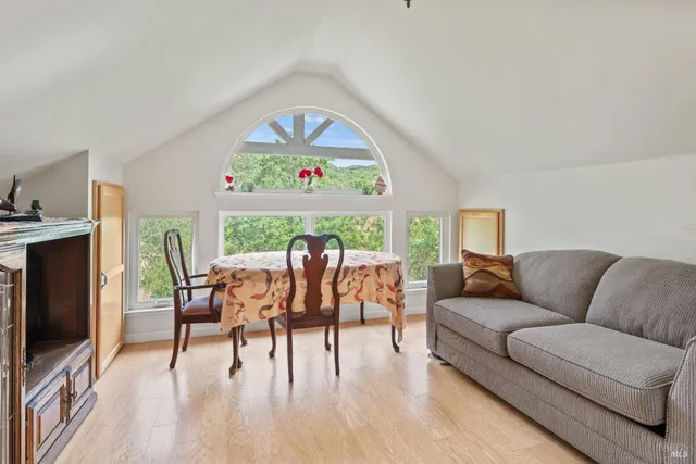a living room with furniture a dining table and a flat screen tv