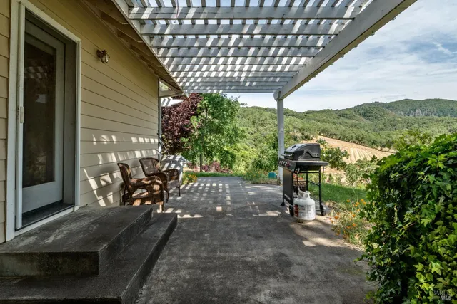 a view of a house with backyard porch and sitting area