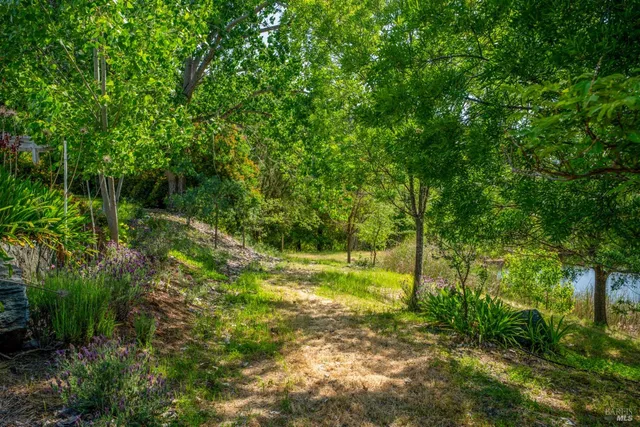 a view of a lake with mountains and valleys in the background