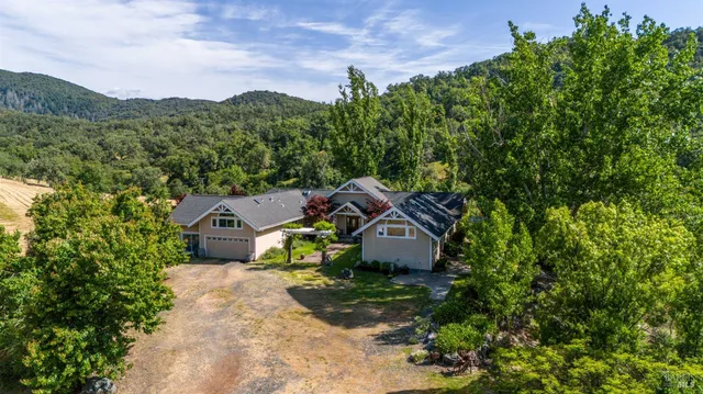 a view of house that has a car parked in front of it