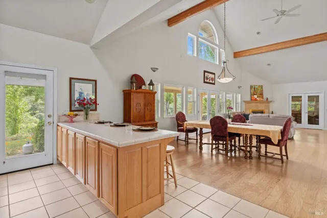 a view of a dining room with furniture and a large window