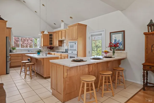a kitchen with stainless steel appliances a sink and a refrigerator