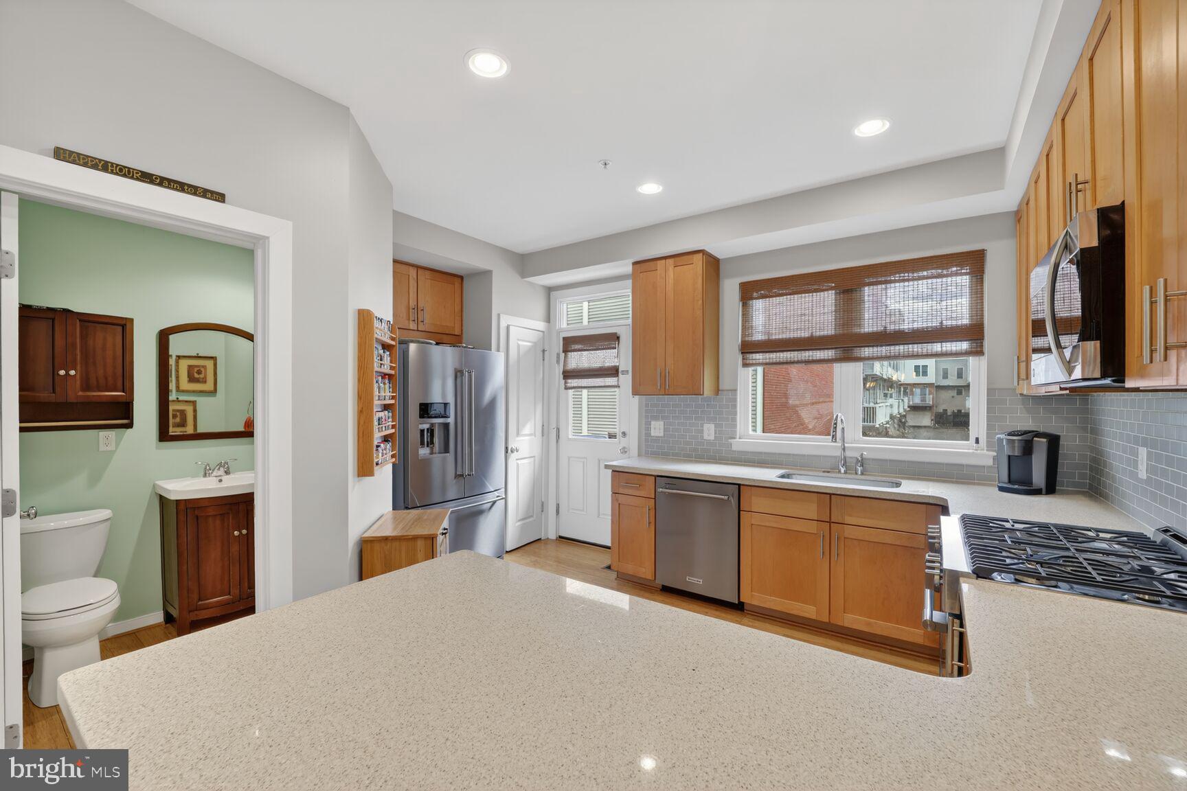 814 3rd Street Southeast Washington, DC 20003 - Photo 11 of 36 a large kitchen with stainless steel appliances granite countertop a refrigerator and a stove top oven