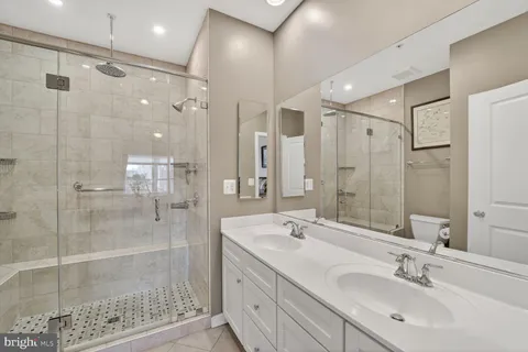 a bathroom with a shower sink and mirror