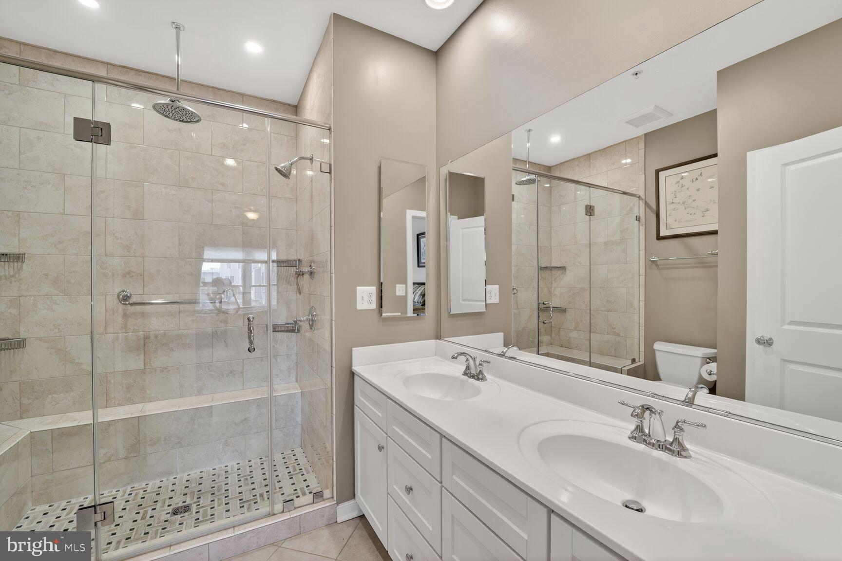 814 3rd Street Southeast Washington, DC 20003 - Photo 17 of 36 a bathroom with a shower sink and mirror