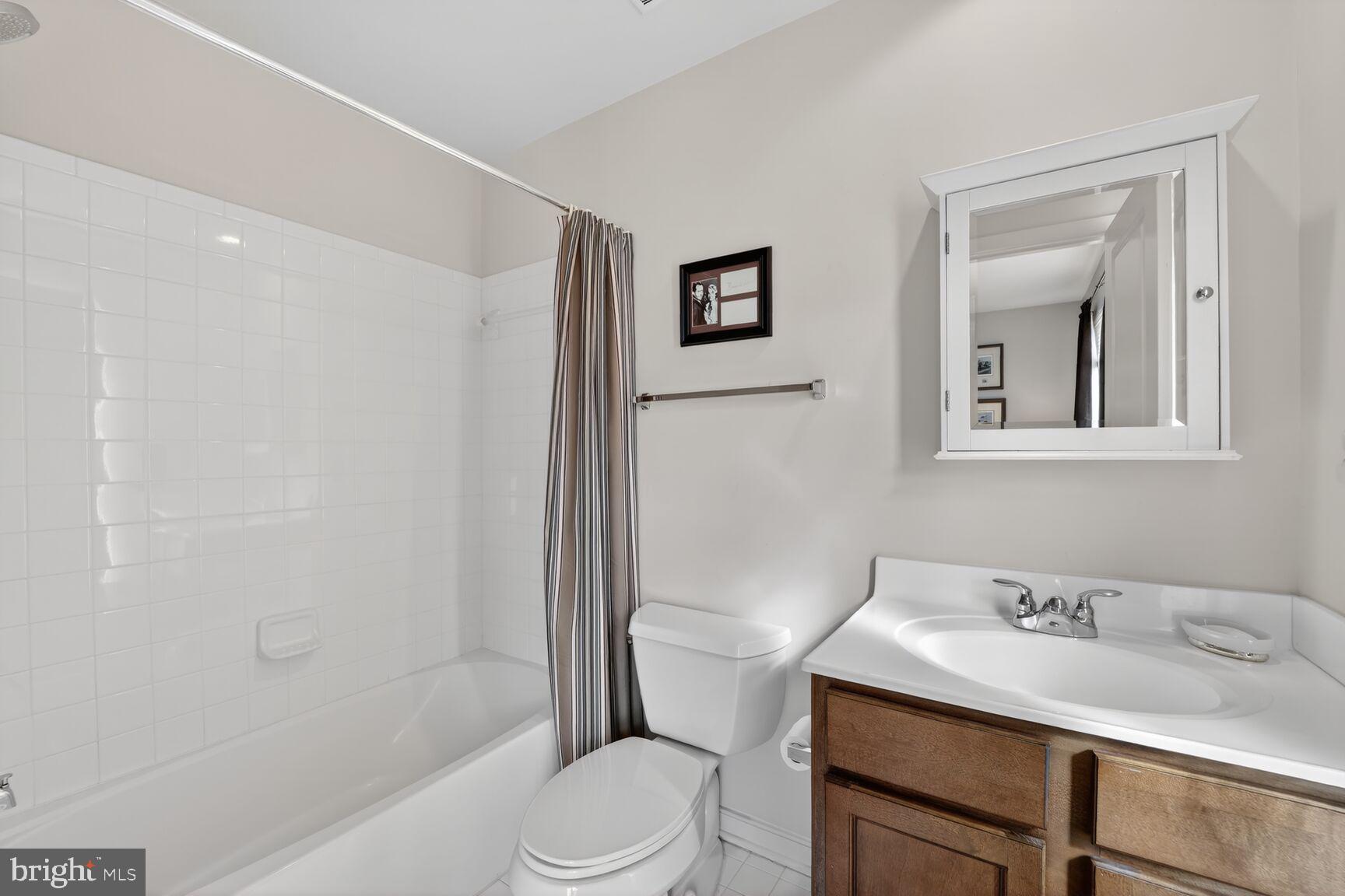 814 3rd Street Southeast Washington, DC 20003 - Photo 26 of 36 a bathroom with a granite countertop sink toilet a mirror and shower