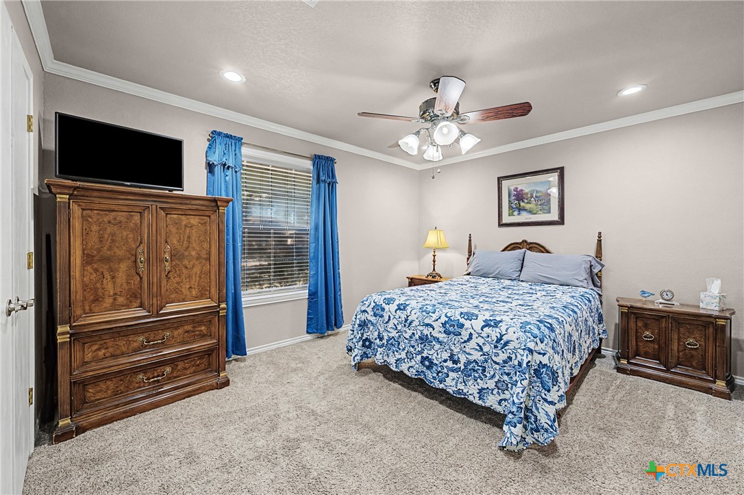 1601 Sunset Circle Cameron, TX 76520 - Photo 23 of 40 a bedroom with a bed and a flat screen tv